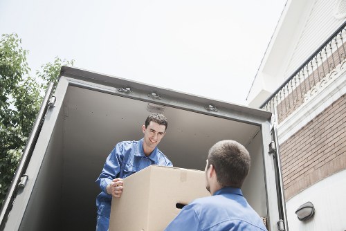 Team unloading packed boxes into a moving truck