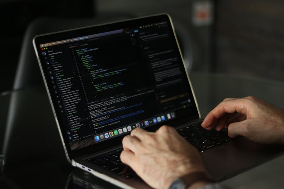 A photograph displaying a densely packed screen of computer code with multicolored syntax highlighting, featuring lines of programming in various colors such as red, blue, green, and white. The code i
